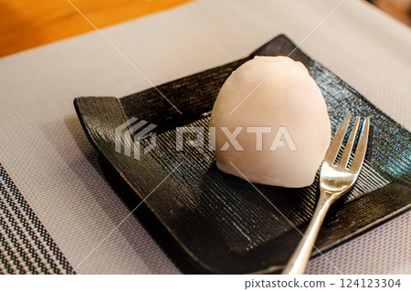 Japanese sweets Daifuku on a black plate and a fork Japanese sweets Daifuku on a black plate and a fork 124123304