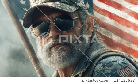 A close-up portrait of a senior military veteran wearing camouflage and aviator sunglasses, with the American flag as a backdrop, symbolizing patriotism and service 124123658