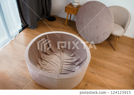 Modern Beige Round Folding Chair in Contemporary Interior Space with Minimalist Design and Neutral Color Palette Modern Beige Round Folding Chair in Contemporary Interior Space with Minimalist Design and Neutral Color Palette 124123915