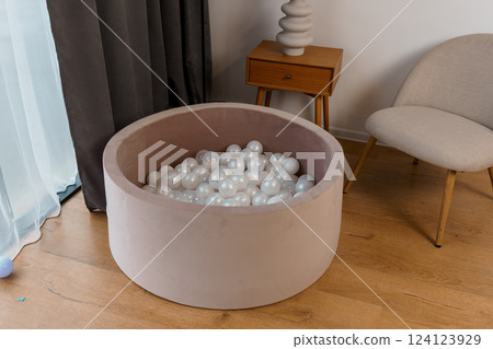 Modern Stylish Children's Ball Pit Filled with White Balls in Contemporary Home Interior Modern Stylish Children's Ball Pit Filled with White Balls in Contemporary Home Interior 124123929