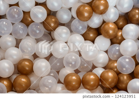 Elegant Background of Shiny White, Golden, and Transparent Plastic Balls for Decoration or Celebration Events Elegant Background of Shiny White, Golden, and Transparent Plastic Balls for Decoration or Celebration Events 124123951