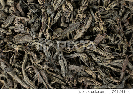 Black large leaf tea leaves macro texture. 124124364
