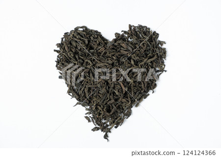 Black Leaf Tea Scattered in Heart Shape on White Background Top View 124124366
