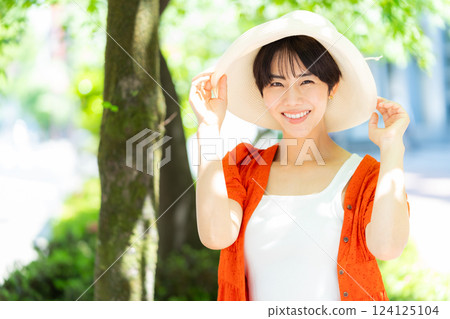 A woman wearing a straw hat A woman wearing a straw hat 124125104