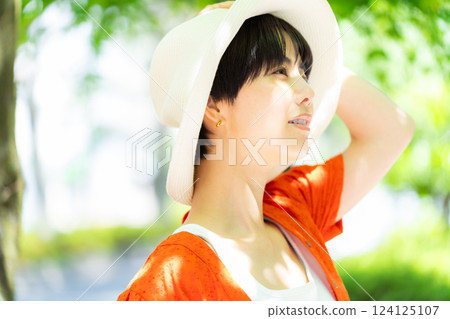 A woman wearing a straw hat 124125107