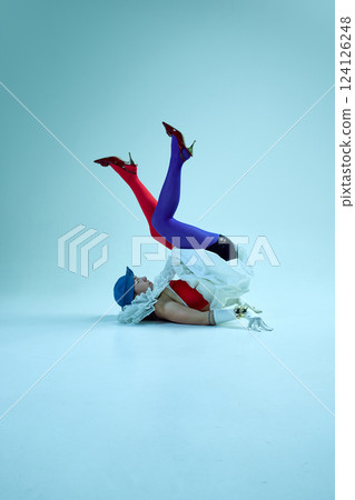 Fashion-forward woman twisting body upside down, corset and gloves evoking vintage-meets-modern aesthetic, emphasizing form over function. Fashion-forward woman twisting body upside down, corset and gloves evoking vintage-meets-modern aesthetic, emphasizing form over function. 124126248