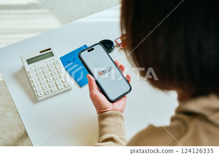 Senior woman operating a smartphone New NISA 124126335