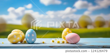 colorful easter eggs on wooden table with landscape background 124126479