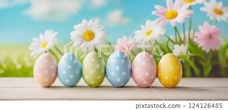 colorful easter eggs on wooden table with landscape background 124126485