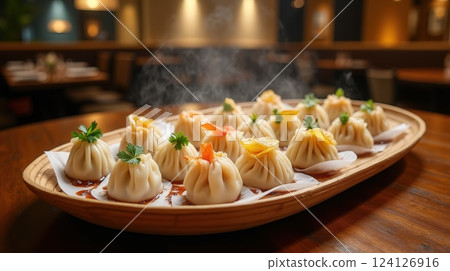 Steaming platter of freshly made dim sum dumplings served at a vibrant Chinese restaurant 124126916