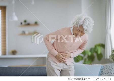 Senior woman suffering from stomachache 124126984