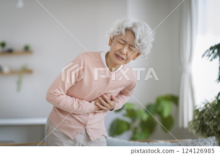 Senior woman suffering from chest pain 124126985
