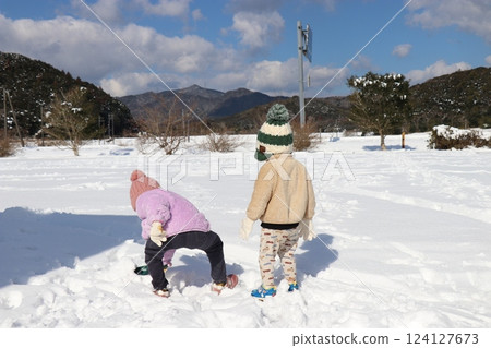 Playing in the snow, girl, boy, brother and sister 124127673