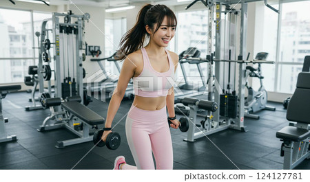 Young woman training in the gym 124127781
