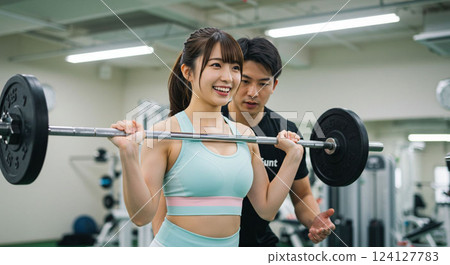 Young woman training in the gym 124127783