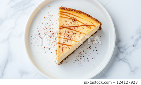 A simply presented caramel-lined cheesecake | Powdered accents 124127928