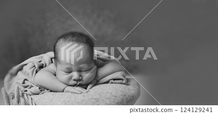 A newborn baby is wrapped in diapers with a wool cap in a basket. Swaddling, maternity hospital, family, ivf, life planning, parenting. A mother's love for her child. Baby food. High quality photo A newborn baby is wrapped in diapers with a wool cap in a basket. Swaddling, maternity hospital, family, ivf, life planning, parenting. A mother's love for her child. Baby food. High quality photo 124129241