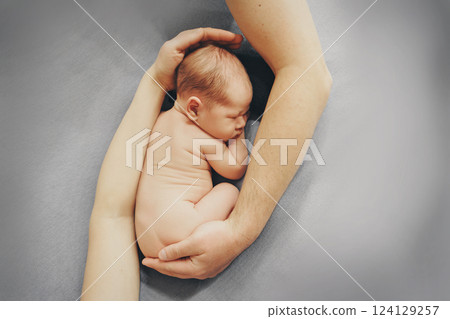 A newborn baby is wrapped in diapers with a wool cap in a basket. Swaddling, maternity hospital, family, ivf, life planning, parenting. A mother's love for her child. Baby food. High quality photo 124129257