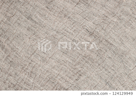 Beige linen fabric texture with folds. Worn linen fabric texture with visible weave and wrinkles. Organic and natural background for rustic and vintage textile designs Beige linen fabric texture with folds. Worn linen fabric texture with visible weave and wrinkles. Organic and natural background for rustic and vintage textile designs 124129949