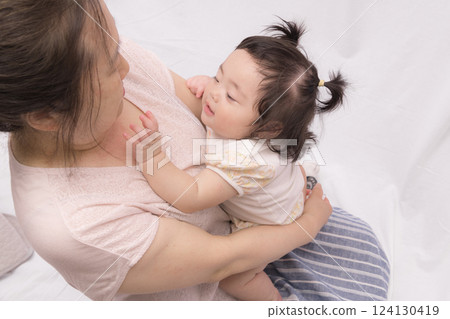 Baby touching grandma's face 124130419