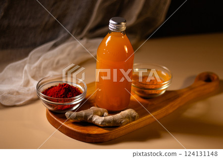 Immunity drink with turmeric powder in bottle. Homemade turmeric tea. Healthy drink with curcuma spices. Turmeric beverage for cleansing skin, normal bowel function and weightloss Immunity drink with turmeric powder in bottle. Homemade turmeric tea. Healthy drink with curcuma spices. Turmeric beverage for cleansing skin, normal bowel function and weightloss 124131148