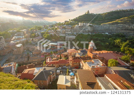 Beautiful sunny landscape of Tbilisi and green mountains on the background of cloudy sky 124131375