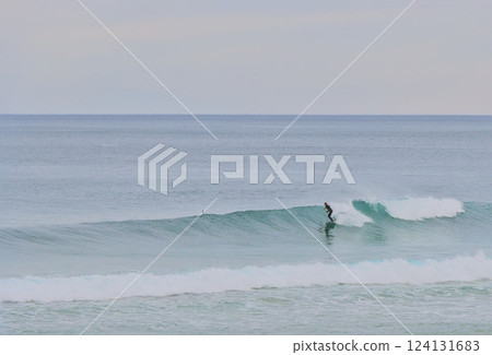 surfer riding a wave surfer riding a wave 124131683