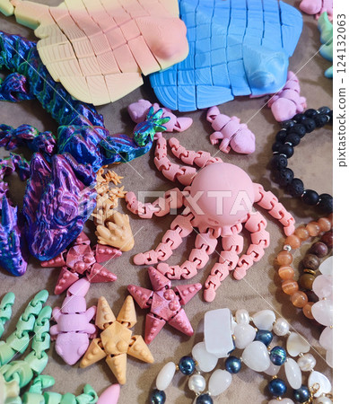Creative multicolored models printed on 3D printer from molten plastic. Different toy objects of different colors created by 3D printer. Concept 3D Printing. New modern 3D Printing additive technology Creative multicolored models printed on 3D printer from molten plastic. Different toy objects of different colors created by 3D printer. Concept 3D Printing. New modern 3D Printing additive technology 124132063