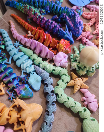 Creative multicolored models printed on 3D printer from molten plastic. Different toy objects of different colors created by 3D printer. Concept 3D Printing. New modern 3D Printing additive technology 124132068