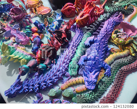 Creative multicolored models printed on 3D printer from molten plastic. Different toy objects of different colors created by 3D printer. Concept 3D Printing. New modern 3D Printing additive technology 124132080