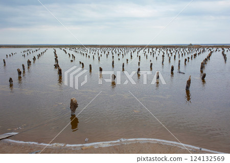 Salt lake with wooden drains in the Lake Baskunchak Salt lake with wooden drains in the Lake Baskunchak 124132569