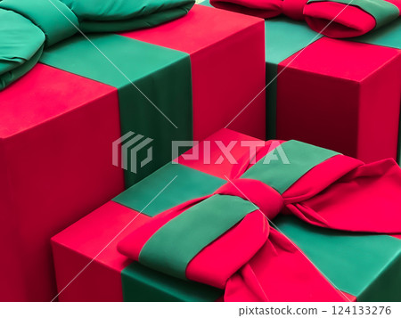 Large red and green Christmas gift boxes with decorative bows creating a festive holiday atmosphere 124133276