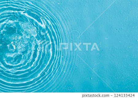 drops on water with circles on a blue background drops on water with circles on a blue background 124133424