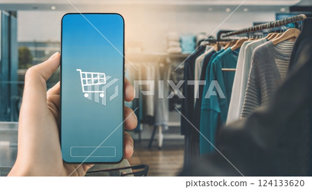 Person shopping online with a smartphone in a stylish retail store Person shopping online with a smartphone in a stylish retail store 124133620
