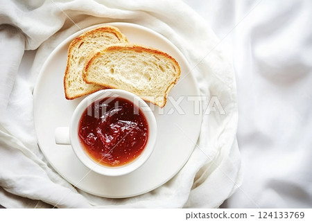 Toasted sliced bread with strawberry jam on white plate for breakfast Toasted sliced bread with strawberry jam on white plate for breakfast 124133769