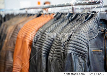 Row of leather motorcycle jackets neatly displayed, highlighting rugged style and protective gear for riders. Concept of biker fashion, durability, and essential safety apparel. Row of leather motorcycle jackets neatly displayed, highlighting rugged style and protective gear for riders. Concept of biker fashion, durability, and essential safety apparel. 124134212