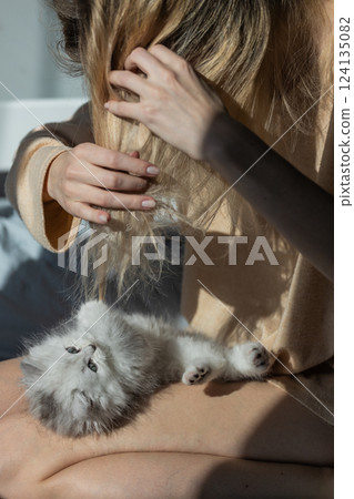A Charming Moment Between a Person and Their Adorable Kitten Highlights the Magic of Companionship and Joy in Everyday Life Amid Natural Light and Cozy Surroundings A Charming Moment Between a Person and Their Adorable Kitten Highlights the Magic of Companionship and Joy in Everyday Life Amid Natural Light and Cozy Surroundings 124135082
