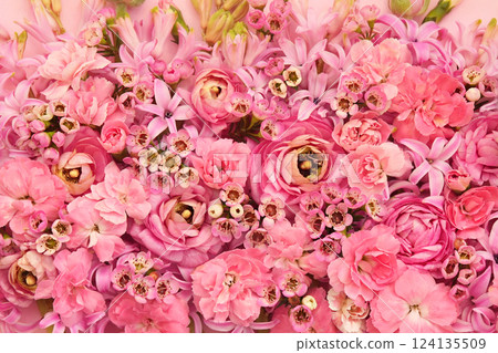 Summer blossoming delicate ranunculus, carnations and waxflowers on blooming flowers festive background, bright and soft bouquet floral card, selective focus 124135509
