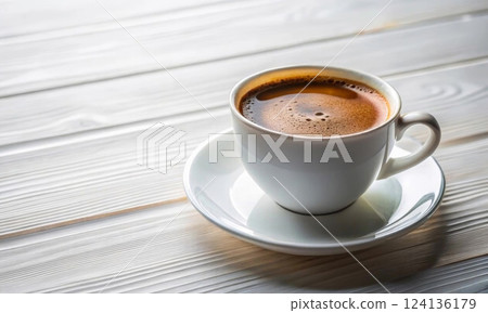 Coffee cup with coffee on a light wooden table 124136179