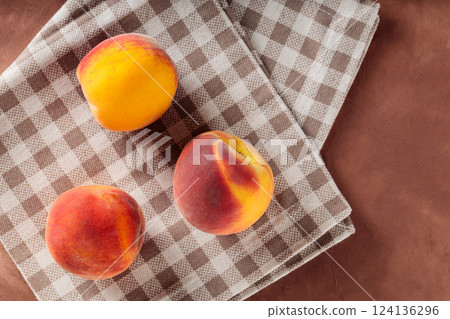 Fresh Peaches on Beige Checkered Napkin, Copy Space 124136296