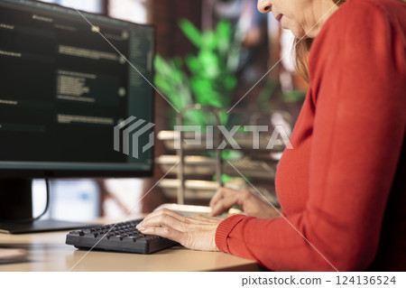 PC user interacting with an AI chat system on her computer at home office, highlighting the evolution of artificial intelligence. Woman employs chatbot services and digital tools for productivity. 124136524