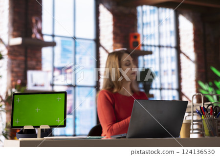 Woman does online research for a project next to copy space display at home, reading articles on the internet at her laptop. Freelancer surfing webpages and gathering data, telework. 124136530