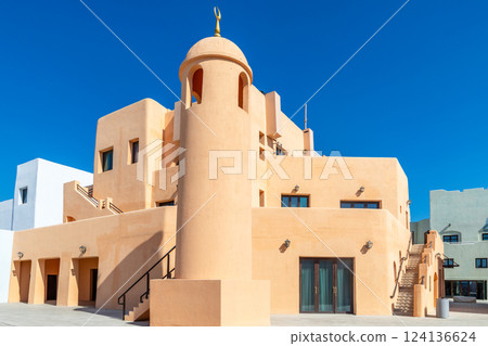 Colorful Mina village district street with modern traditional arab buildings and minaret, Doha, Qatar 124136624