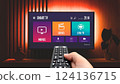 Man watching TV, remote control in hand 124136715