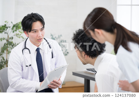 An image of a doctor examining an unwell businessman. Also used for psychiatric counseling. An image of a doctor examining an unwell businessman. Also used for psychiatric counseling. 124137080