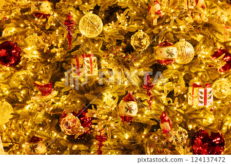 Christmas tree with glass balls, bird, red icicles. Christmas tree with glass balls, bird, red icicles. 124137472