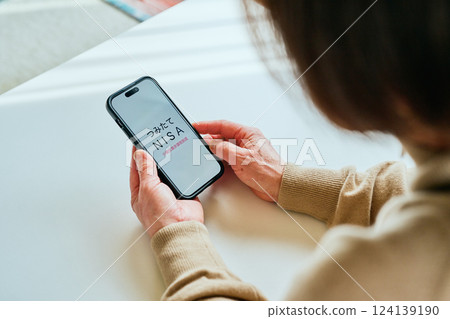 Senior woman using smartphone Tsumitate NISA Senior woman using smartphone Tsumitate NISA 124139190