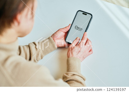 Senior woman using smartphone iDeCo 124139197