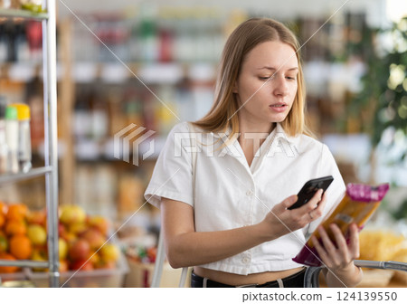 Young woman scanning qr code for spaghetti 124139550