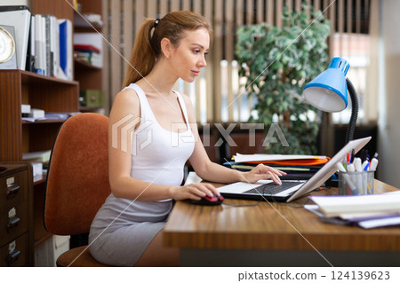 Portrait of a young sexy woman business manager working at a computer 124139623